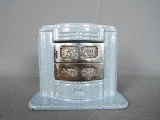 An Art Deco, cast iron enamel money bank, modelled as a stove, by Ciney,