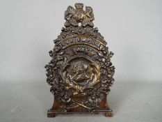 An early 20th century cast iron money bank, marked 'Our Empire, Bank', approximately 17 cm (h).