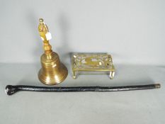 A large brass bell marked 'Titanic 1912', walking stick and similar.