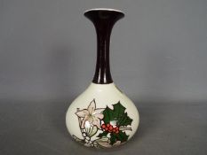A Lorna Bailey, limited edition bottle vase decorated with holly and mistletoe,