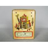 A vintage German, tinplate novelty money bank, one side printed with two children and their parents,