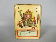 A vintage German, tinplate novelty money bank, one side printed with two children and their parents,