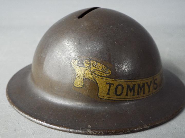 A World War One period novelty, tin money bank in the form of a helmet, titled 'Tommy's Tin Hat' 4. - Image 3 of 6