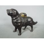 A cast iron money bank in the form of a St Bernard dog,