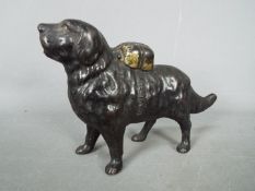 A cast iron money bank in the form of a St Bernard dog,