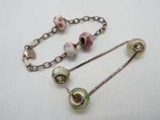 Two silver bracelets with three silver Pandora style fobs