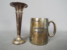 A small hallmarked silver beaker and small silver bud vase, approximately 11.