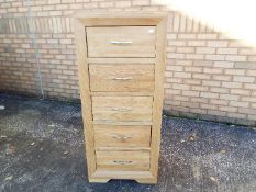 A modern, light oak, tall boy chest of five drawers by J. B.