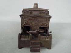 A late 19th century, cast iron, mechanical money bank by, H.L.