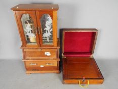 A jewellery cabinet with upper section having twin glazed doors,