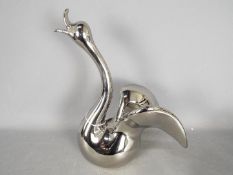 Unused Retail Stock - A boxed ceramic swan with metallic, silver coloured finish,