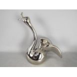 Unused Retail Stock - A boxed ceramic swan with metallic, silver coloured finish,