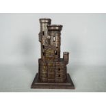 A cast iron, novelty money bank in the form of a castle, marked to the plinth 'Bank',