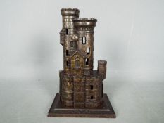 A cast iron, novelty money bank in the form of a castle, marked to the plinth 'Bank',