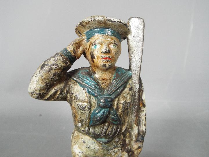 A cold painted, cast iron, novelty money bank in the form of a saluting sailor, - Image 4 of 5