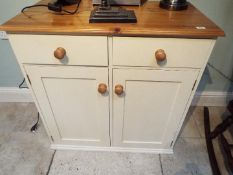 A pine cupboard with two upper drawers measuring approximately 91 cm x 92 cm x 50 cm.