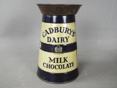 A Cadbury's Dairy Milk Chocolate tinplate, advertising money bank in the form of a milk churn,