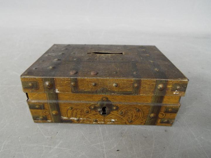 A vintage money bank / tin in the form of a metal bound chest,