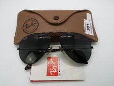 A pair of Ray-Ban sunglasses, model RB3052, left lens etched 'BL', with leaflet and case.
