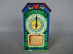 A vintage, German, tinplate chocolate dispenser type money bank,