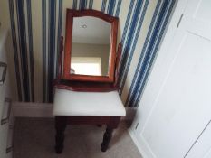 A dressing table stool and mirror.