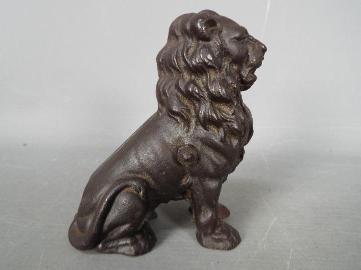 A cast iron money bank in the form of a seated male lion, - Image 3 of 5
