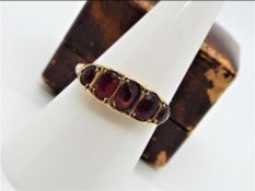 A 9ct gold and garnet ring, size O + ½, approximately 1.9 grams all in.