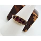 A 9ct gold and garnet ring, size O + ½, approximately 1.9 grams all in.