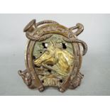 A cast iron 'Tally Ho' money bank with horse, hound and fox, registration marks verso,