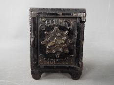 A late 19th century cast iron money bank in the form of a safe, marked 'Security Safe Deposit',