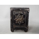 A late 19th century cast iron money bank in the form of a safe, marked 'Security Safe Deposit',