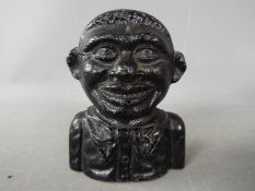 A cast iron money bank in the form of a non-mechanical bust of a young boy,