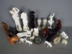 Lot to include wooden animal carvings, alabaster carvings, ceramic horses,