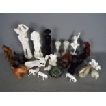 Lot to include wooden animal carvings, alabaster carvings, ceramic horses,