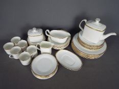 Royal Doulton - A collection of Royal Doulton dinner and tea wares in the Gold Concord pattern,