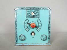 A vintage German tinplate money bank in the form of a valve radio, approximately 10.