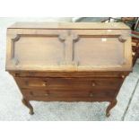 A writing bureau with fall front above two drawers and having fitted interior,