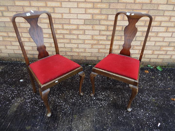 Two chairs with upholstered seats.