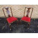 Two chairs with upholstered seats.