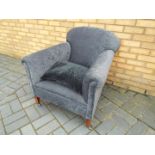 An upholstered armchair on castors.