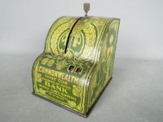 An early 20th century tin litho Commonwealth Bank money bank in the form of a cash register,