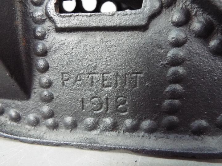 A cast iron money bank in the form of a tank, modelled as a Mark IV Male Tank, marked 'Patent 1918', - Image 6 of 7