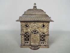 A novelty cast iron money bank of architectural form, depicting a bank,
