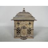 A novelty cast iron money bank of architectural form, depicting a bank,