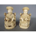 A pair of early 20th century Chinese ivory figures of an Emperor and an Empress seated on 'Dragon