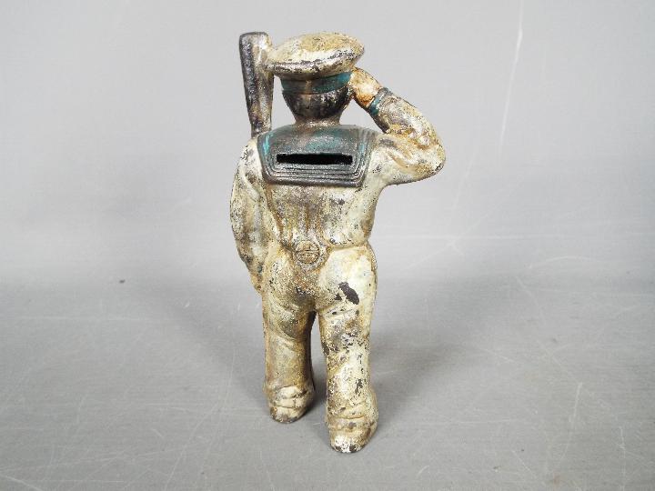 A cold painted, cast iron, novelty money bank in the form of a saluting sailor, - Image 2 of 5