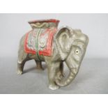 A vintage cast aluminium, novelty money bank in the form of an elephant with howdah,