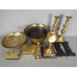 A collection of brassware to include a Mercedes clock, Chinese bowls, candlesticks,