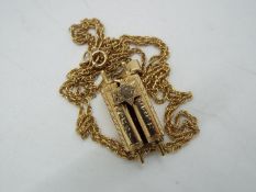 A 9ct yellow gold Torah scroll pendant on 9ct chain (54 cm), approximately 6.3 grams all in.