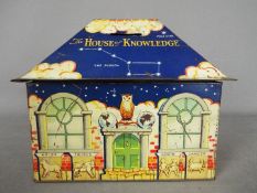 A William Crawford & Sons Ltd 'House of Knowledge', tinplate biscuit tin / money bank,